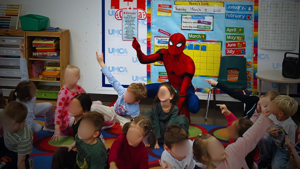 Superhero performer with children at a party event